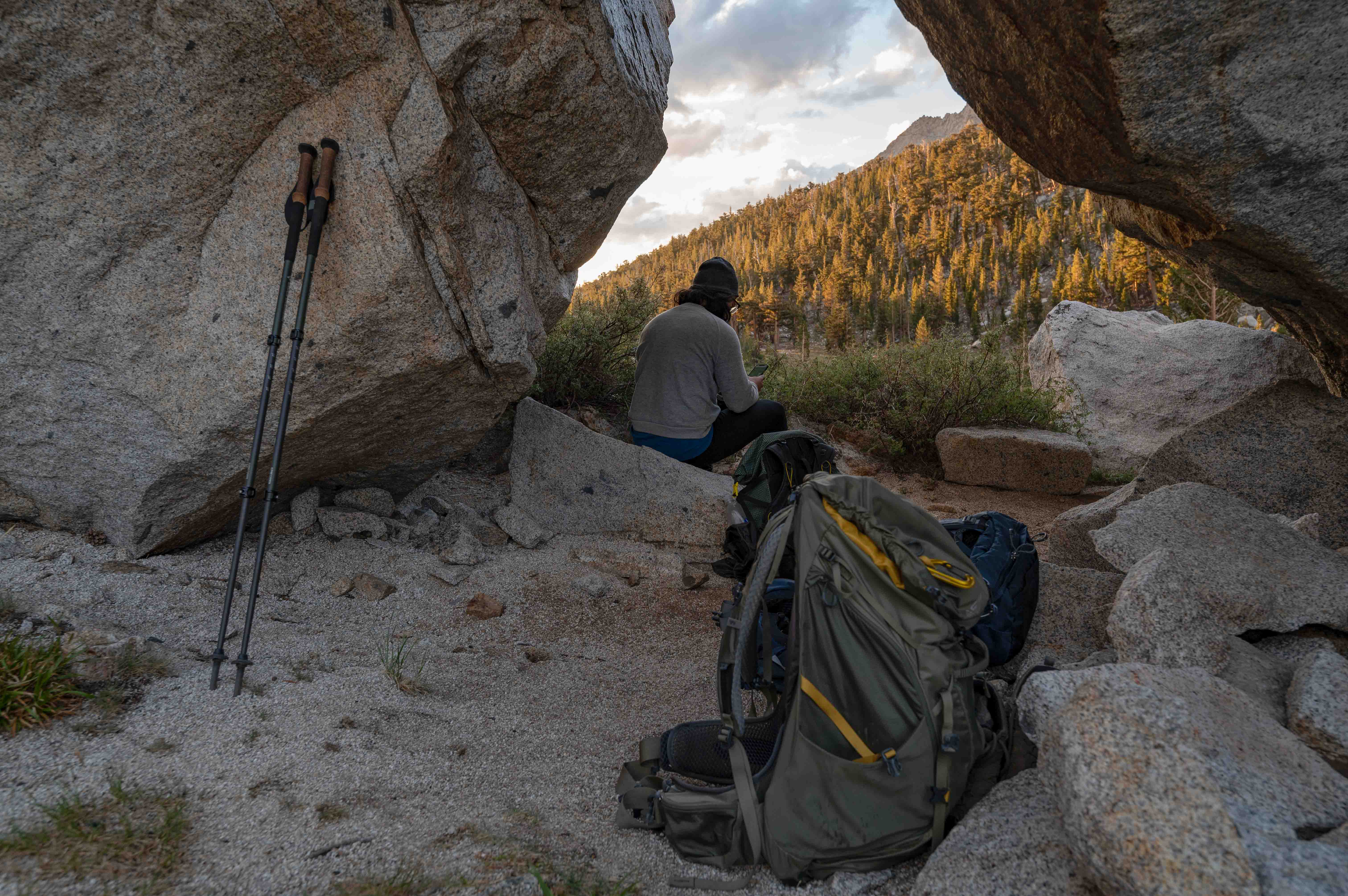 Man reads by some rocks