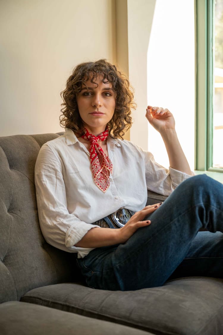 Woman looks up from couch