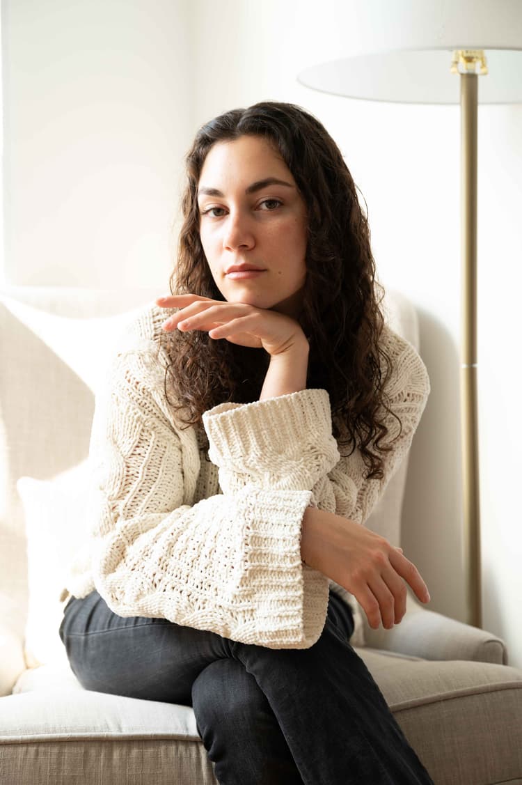 Woman looks ahead from chair