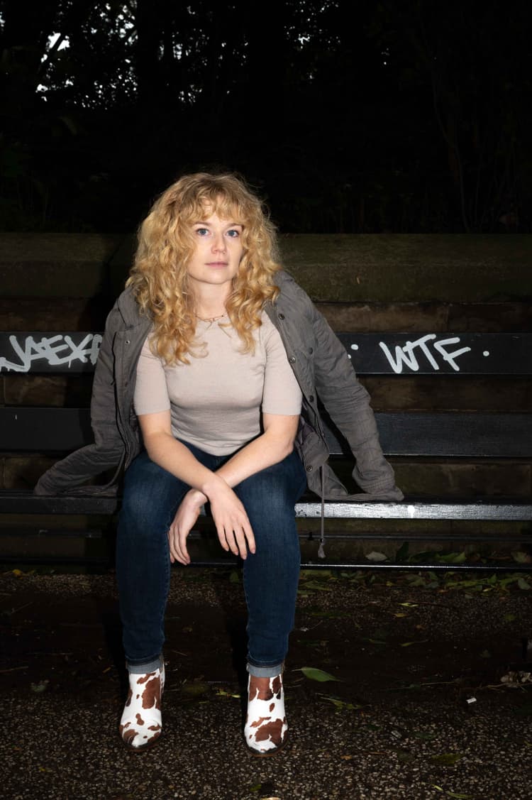 Woman sits on bench