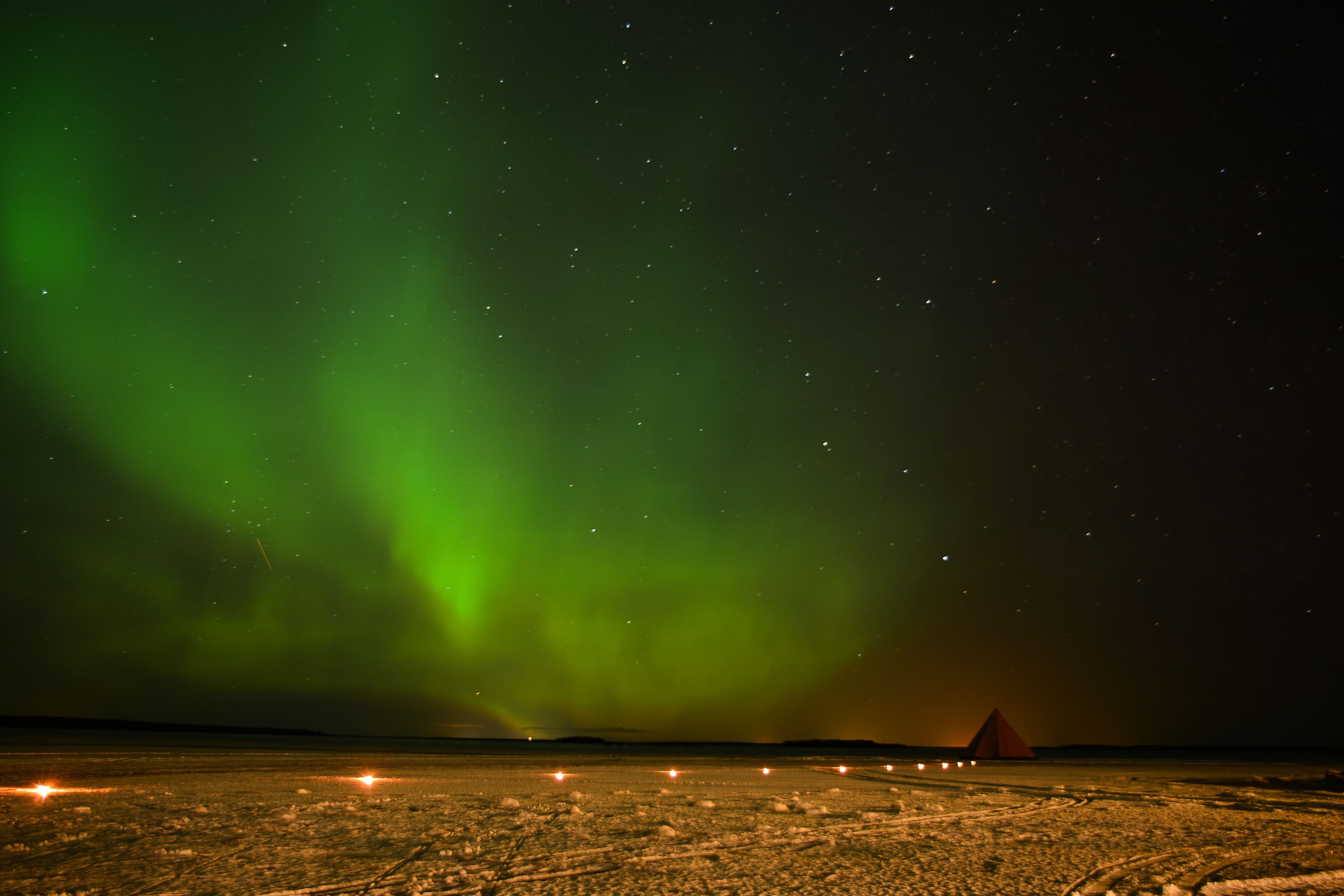 The northern lights over a teepee in Sweden