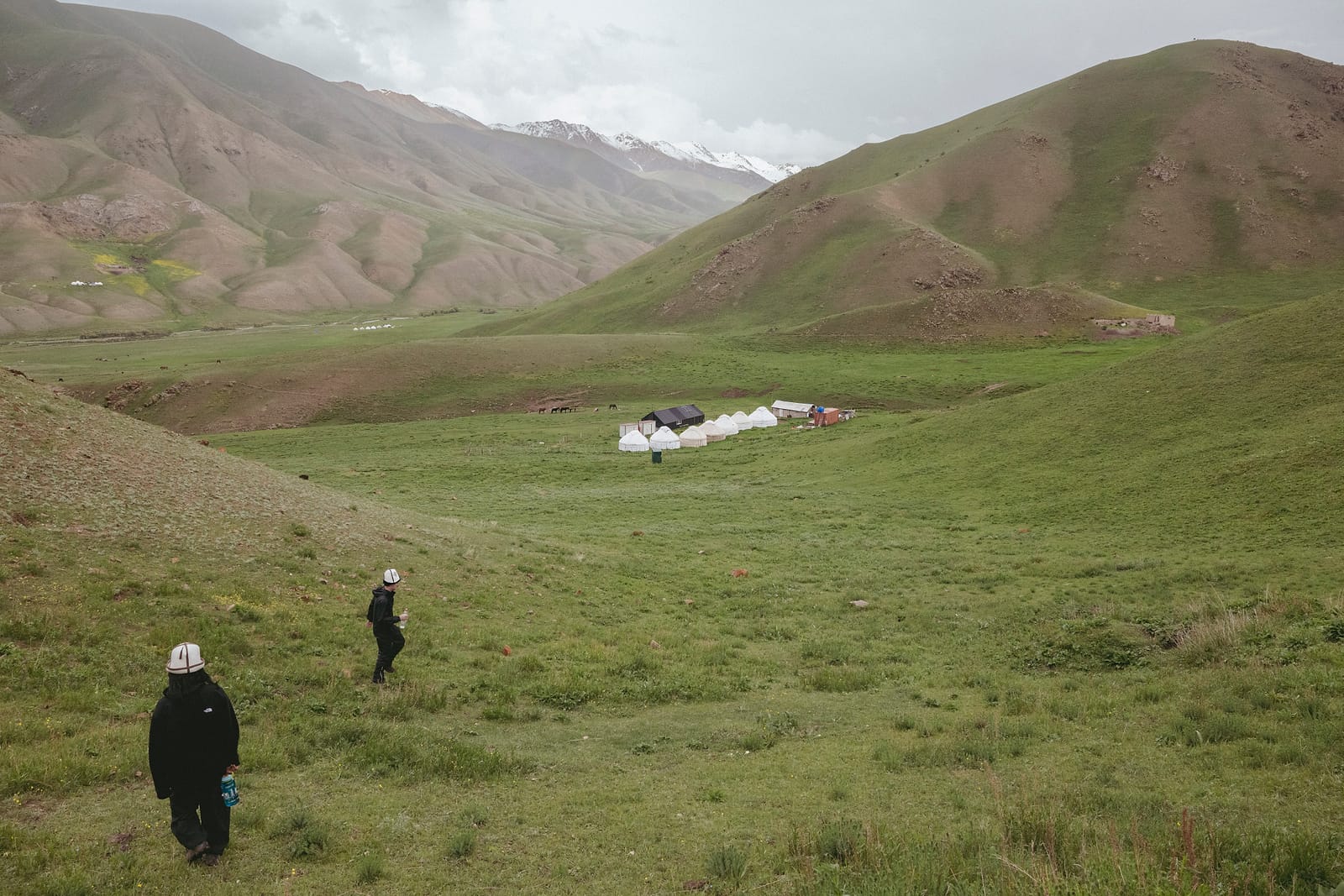 Two figures walking out toward the camp